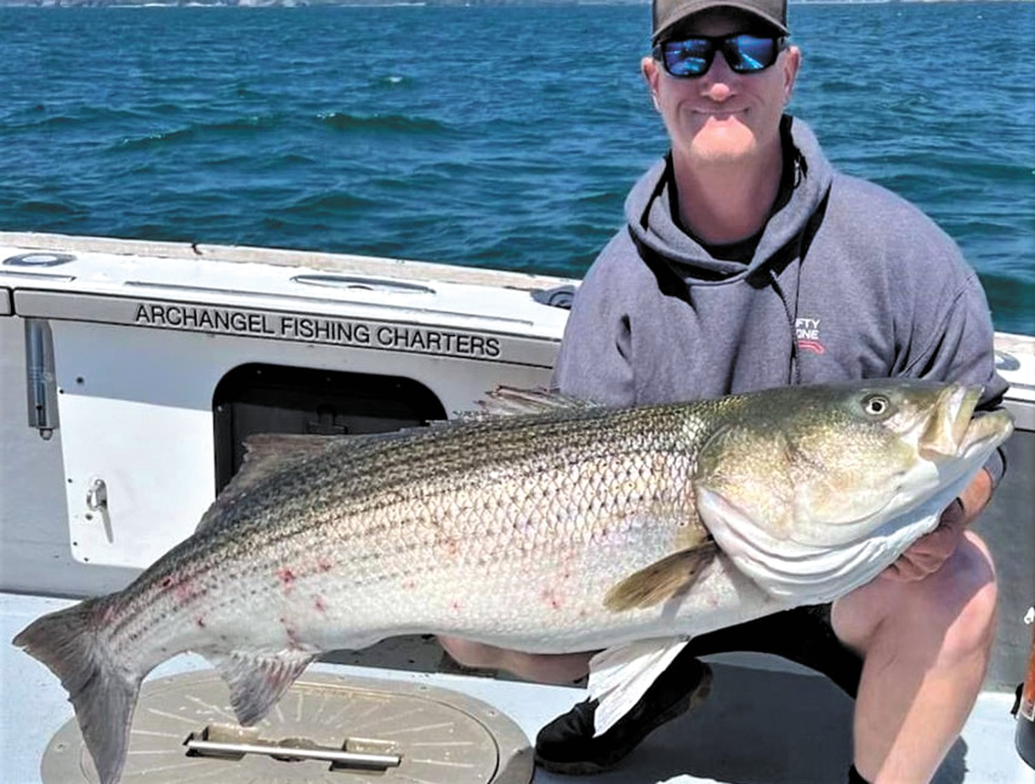 BIG BASS: Capt. Mike Littlefield of Archangel Charters, Newport, caught this 55 pound striped bass last week.